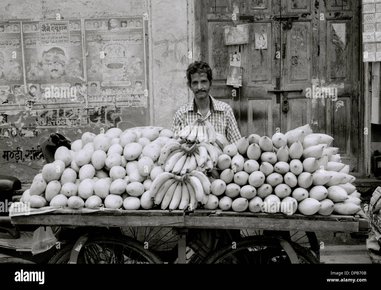 A fruit seller stall at the market in Udaipur in Rajasthan in India in South Asia. Business Trade Food Portrait Street Markets Urban Life Occupation Stock Photo
