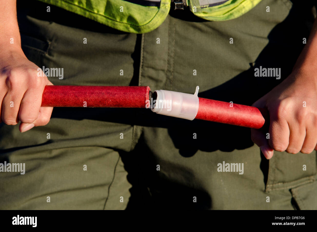A police officer lighting flares Stock Photo Alamy