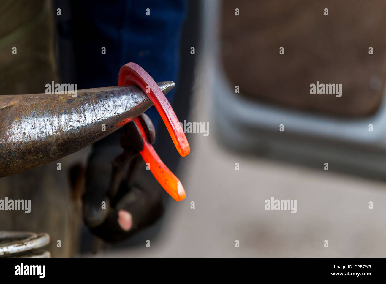 Red hot glowing horseshoe on anvil Stock Photo