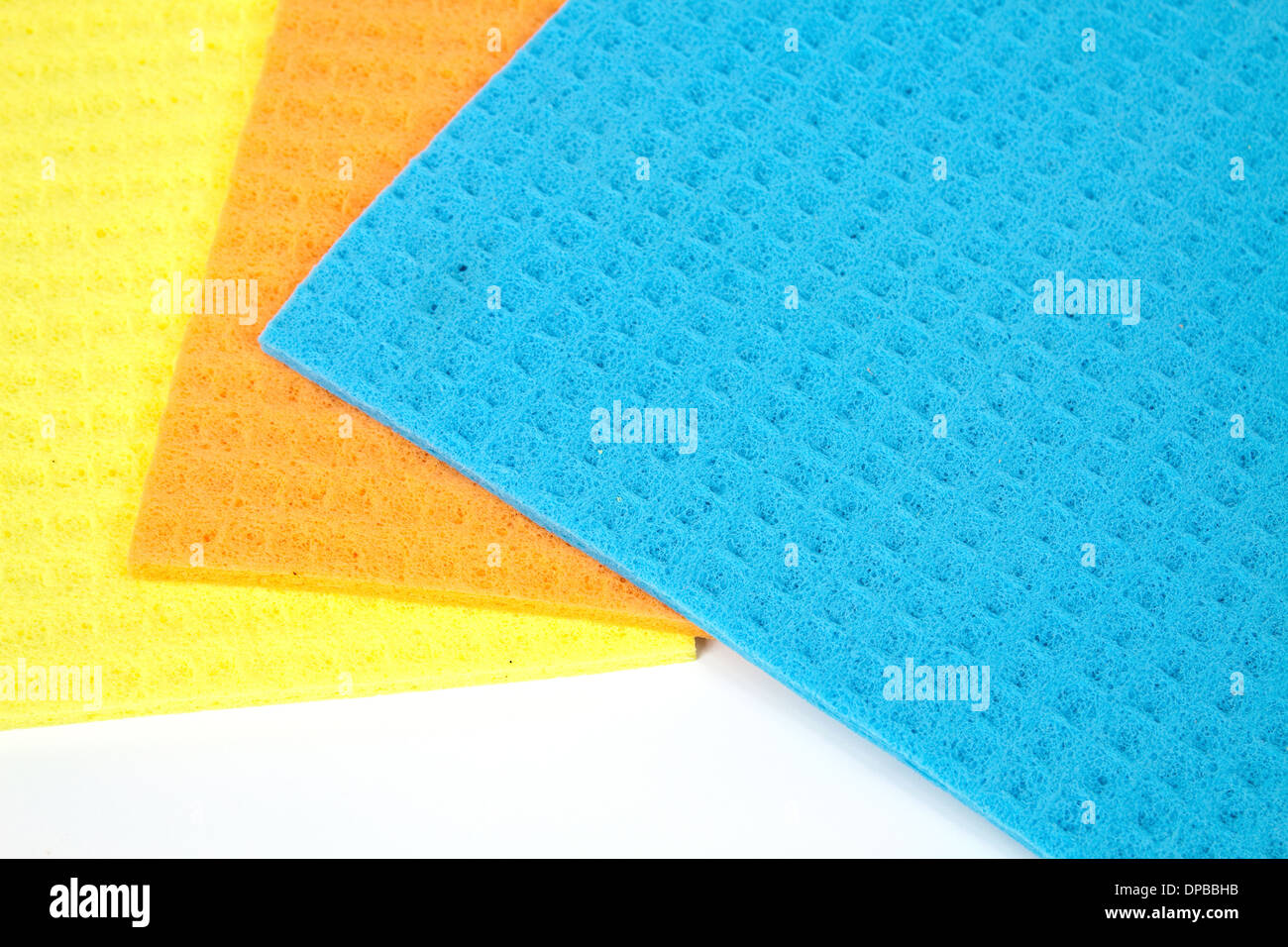 Kitchen towels porous absorbent material in yellow, orange and blue Stock Photo