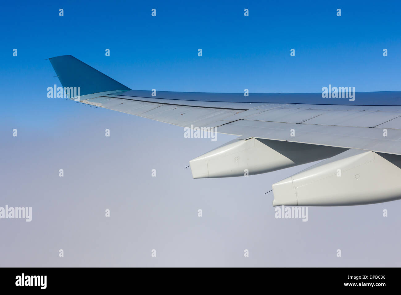 View of airplane wing over clouds Stock Photo