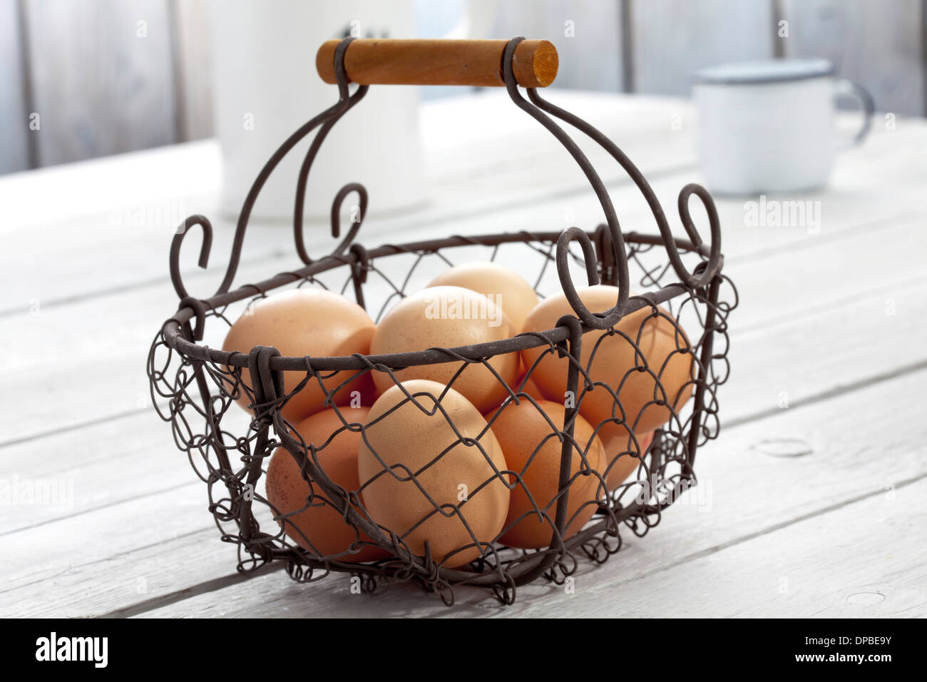 Fresh eggs in wire basket Stock Photo Alamy