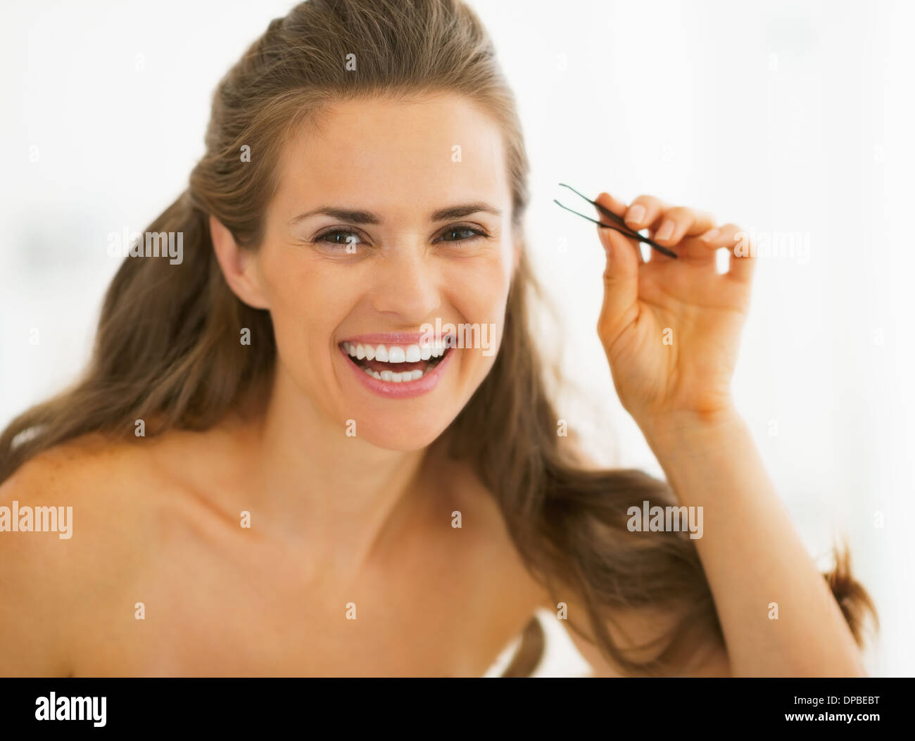 Happy young woman with tweezers Stock Photo Alamy