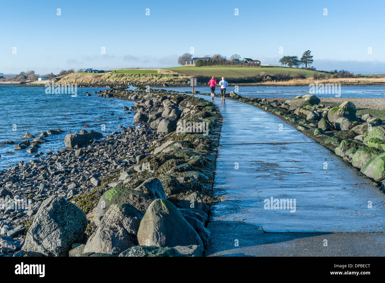 Joggers cross the causeway at Island Hill, Comber, Co Down, Northern Ireland. Stock Photo