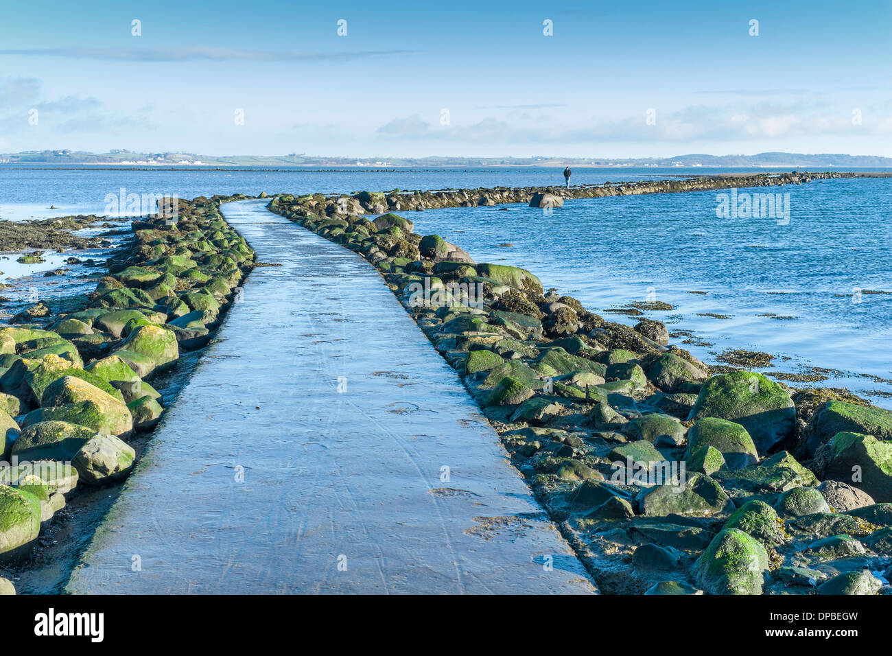 A sole walker crosses the causeway at Island Hill, Comber, Co Down, Northern Ireland. Stock Photo