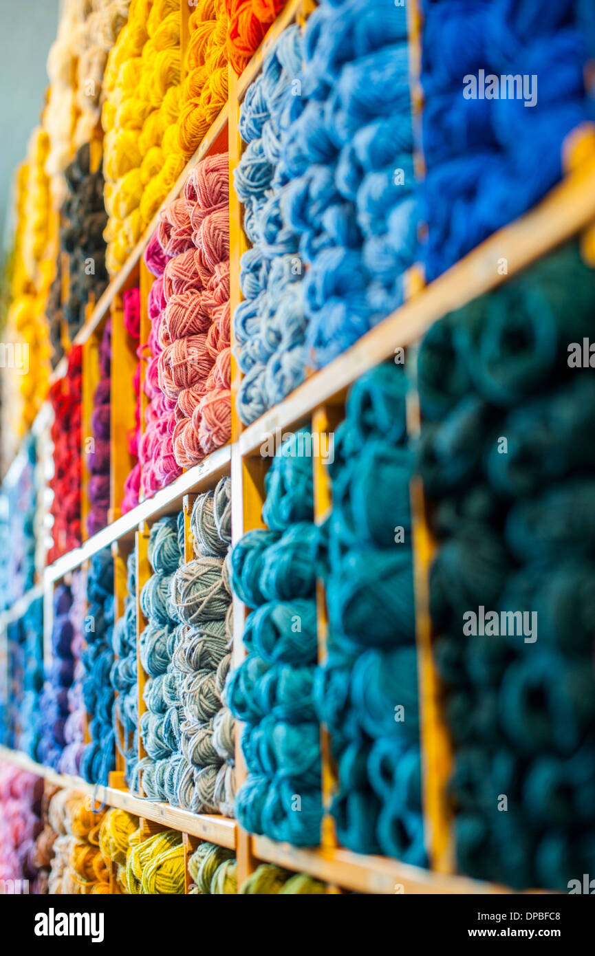 Yarn in multiple colors in sales stand Stock Photo Alamy