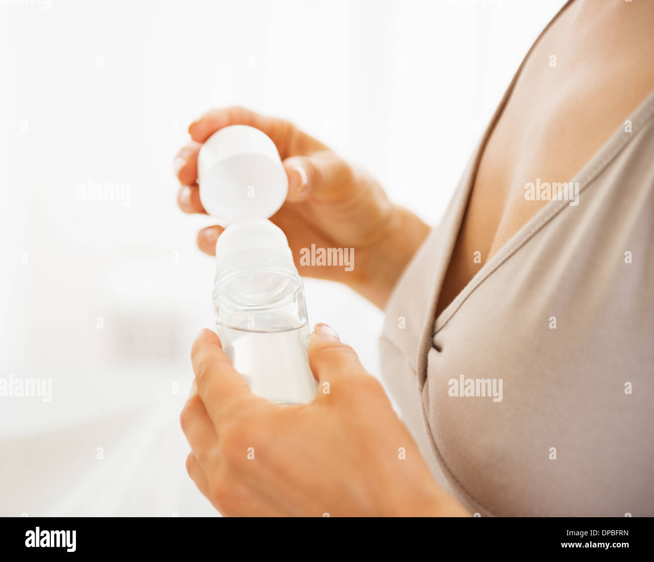 Closeup on young woman using deodorant Stock Photo