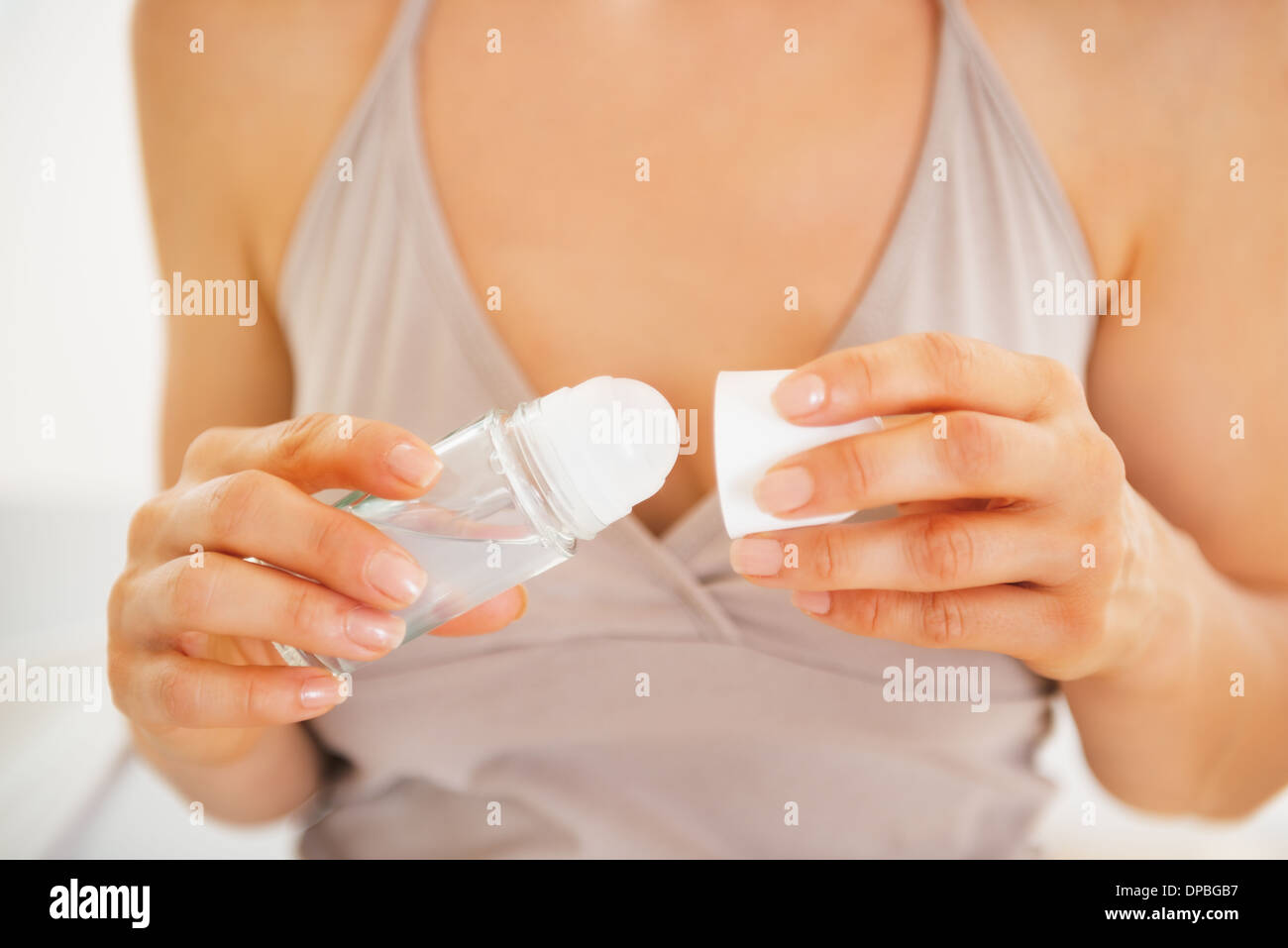 Closeup on young woman using deodorant Stock Photo Alamy
