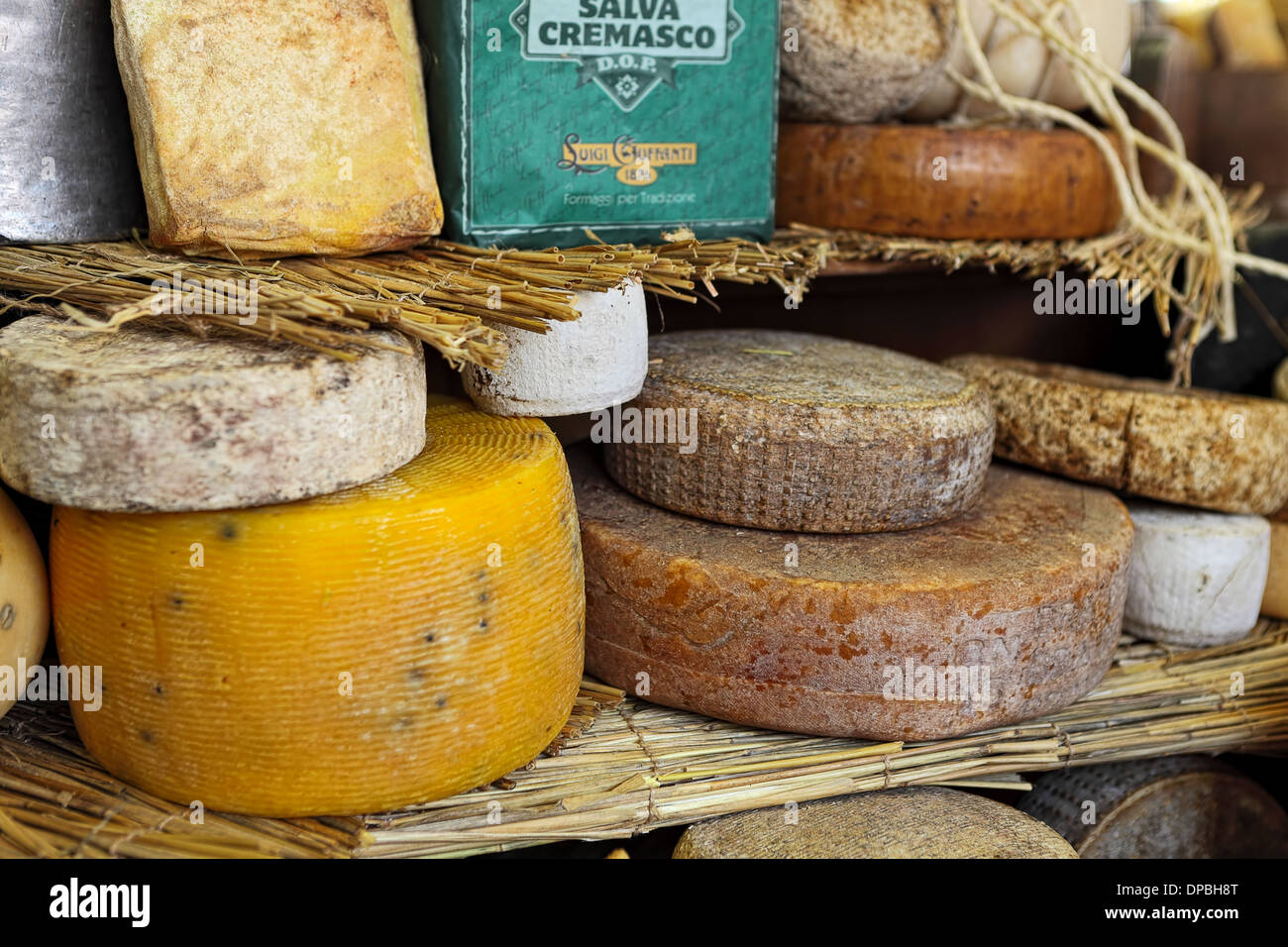 Different types of mature hard cheese on the stand in Italy. Stock Photo
