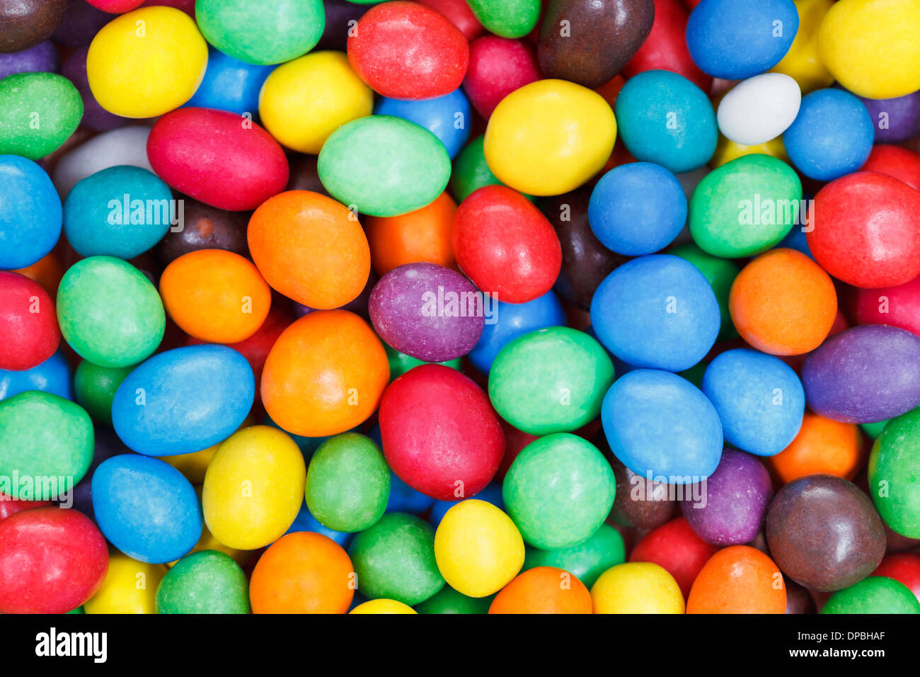 background from multi-colored chocolate sweet candies close up Stock ...