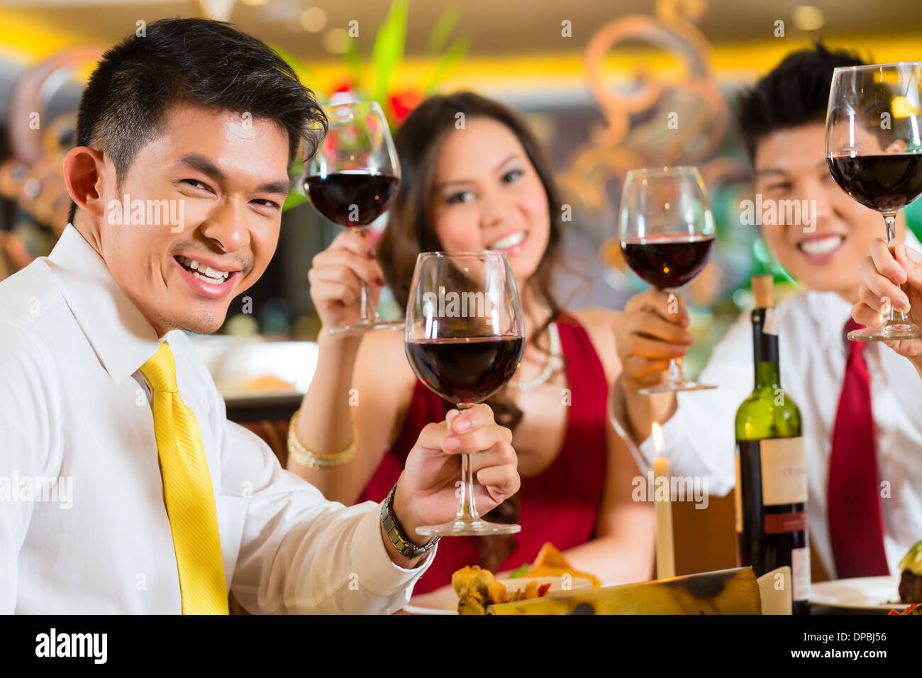 Two Couples or friends or business people toasting while dinner or