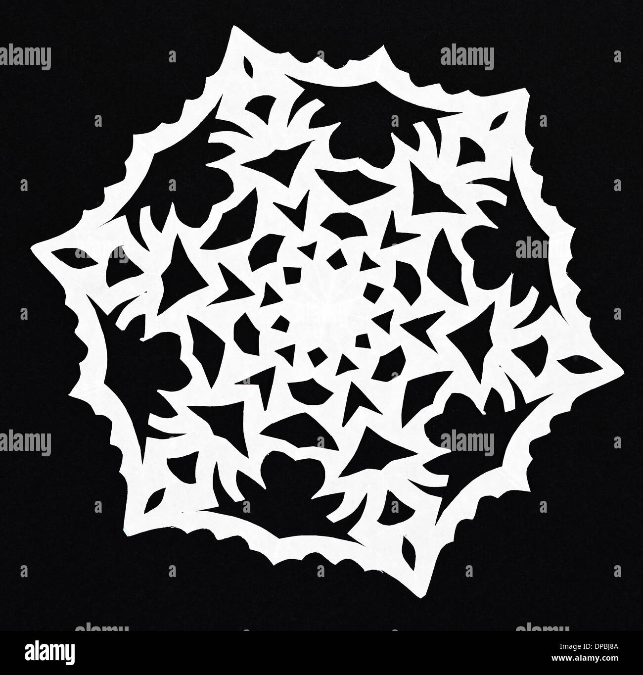 hand made cut out white snowflake on black paper background Stock Photo ...