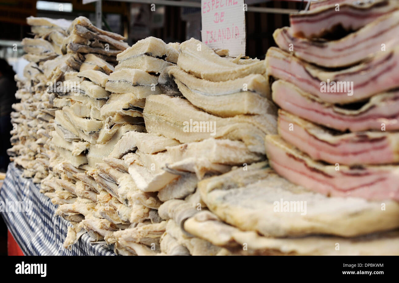 icelandic salted dried cod and slabs of bacon stacked in stand of the