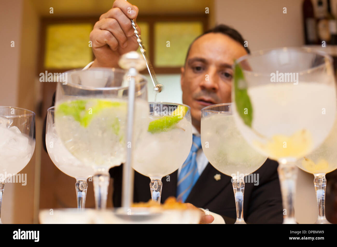 Making and trying various gin and tonic cocktails. Stock Photo