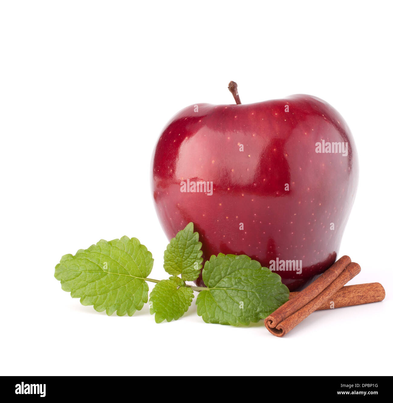 Red apple, cinnamon sticks and mint leaves still life isolated on white cutout. Stock Photo