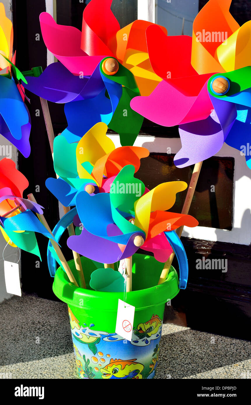 Colorful toy windmill propellers in toy bucket Stock Photo