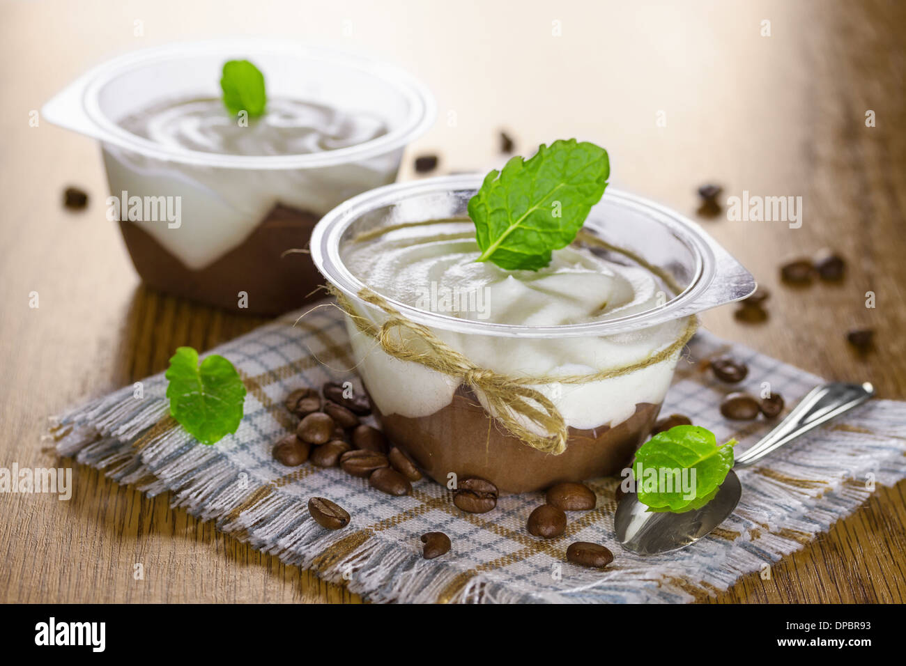 Chocolate pudding with whipped cream and mint leaves Stock Photo