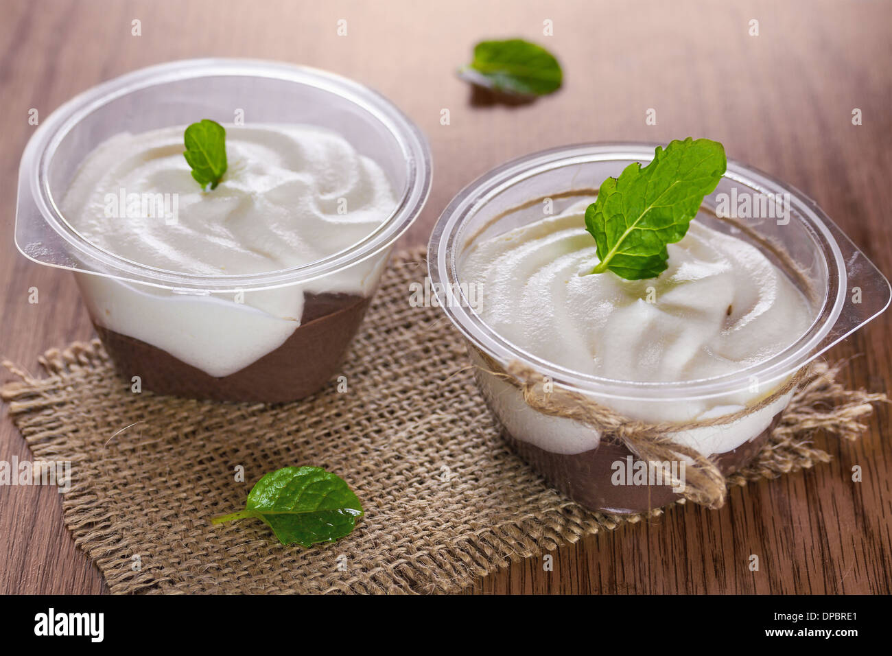Chocolate pudding with whipped cream and mint leaves Stock Photo
