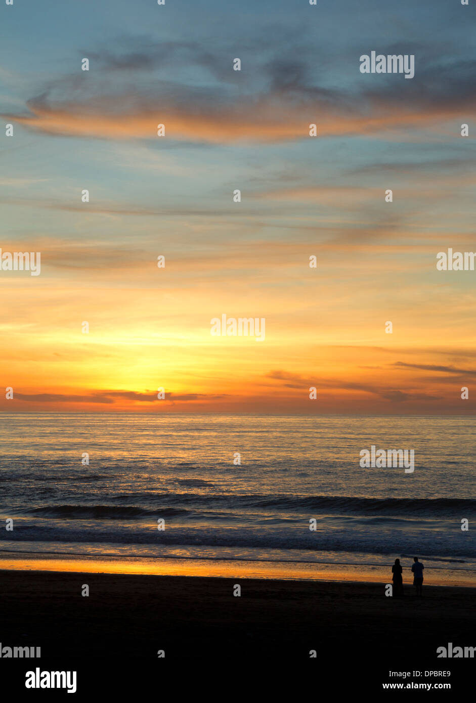 People Watching the Sunset over the Pacific Ocean Stock Photo