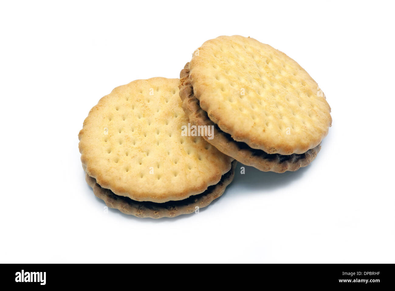 Two biscuits isolated with cocoa cream on a white background. Stock Photo
