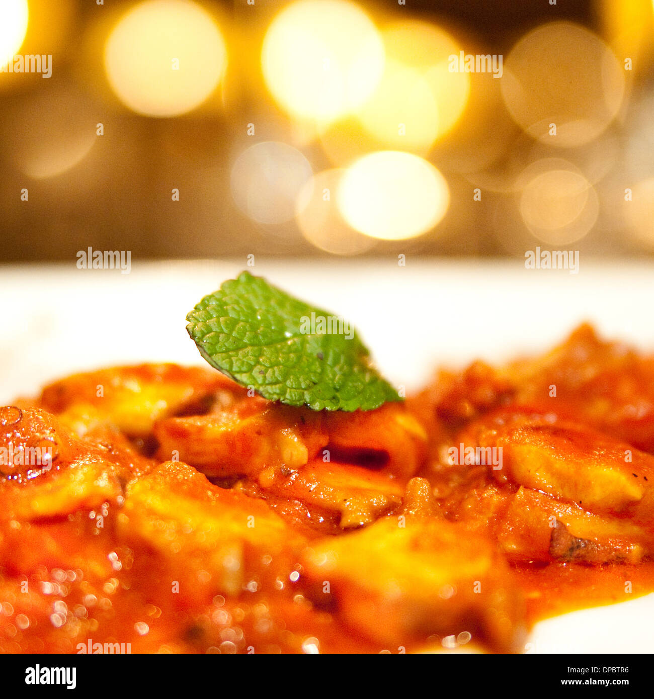 Homemade pasta with tomato sauce and mint on top. Stock Photo