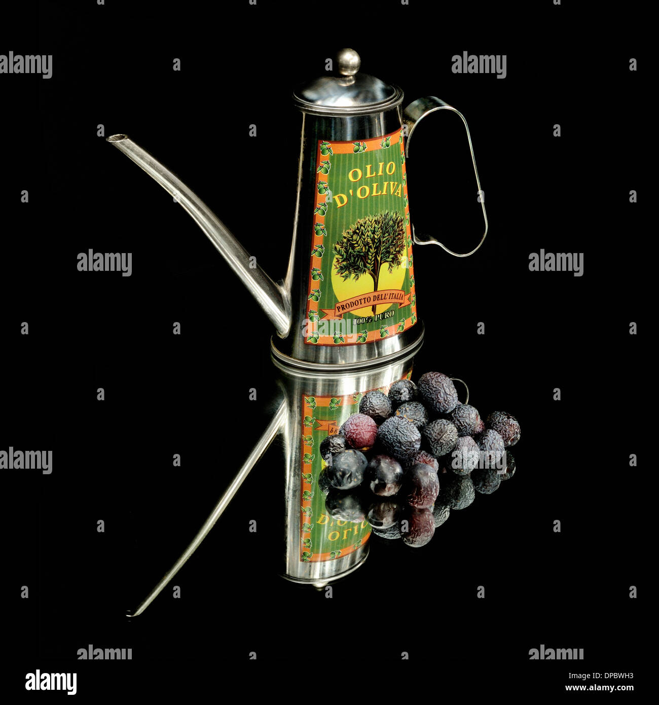 Black Olives with Oil Can on mirror and black background. Stock Photo