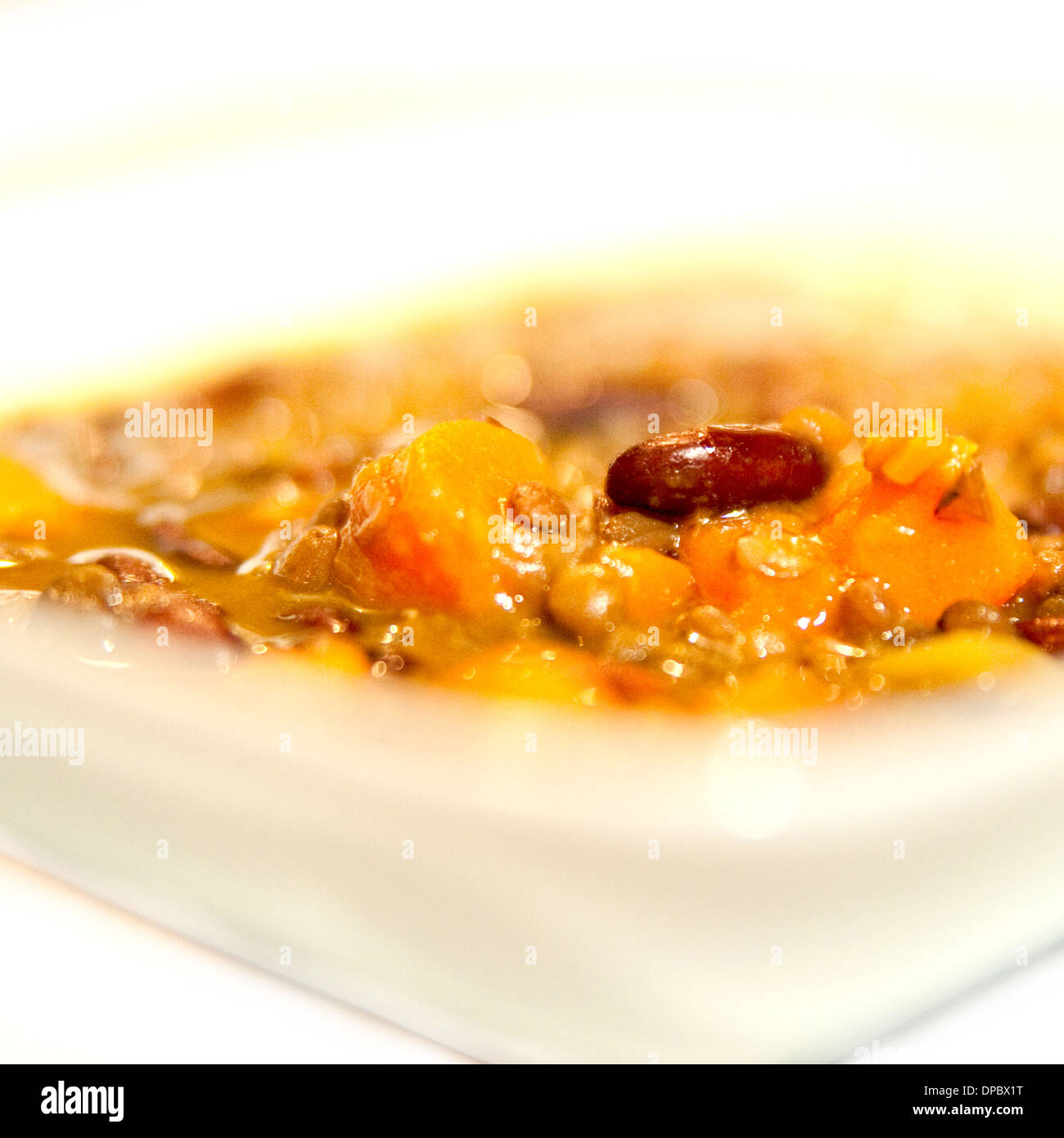 Black Bean soup bowl on white background. Zuppa di Fagioli. Stock Photo