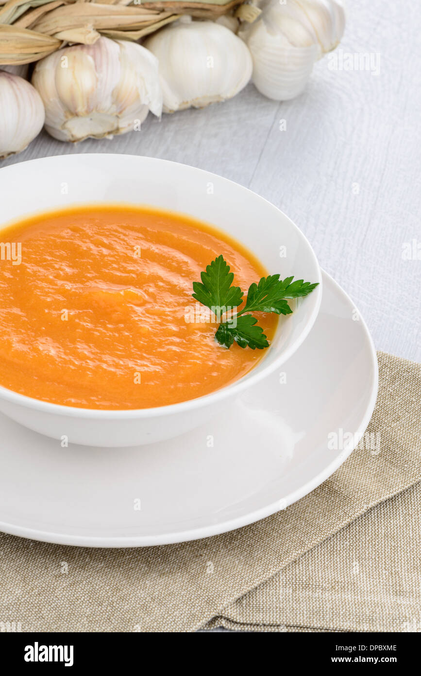 Pumpkin soup on white wood background Stock Photo - Alamy