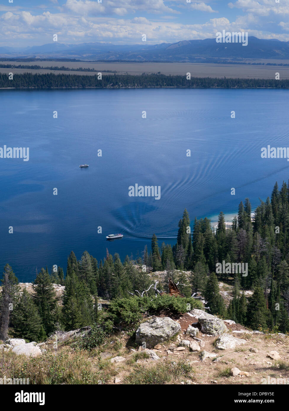 Tourist shuttle boat arriving at west shore boat dock on Jenny Lake in