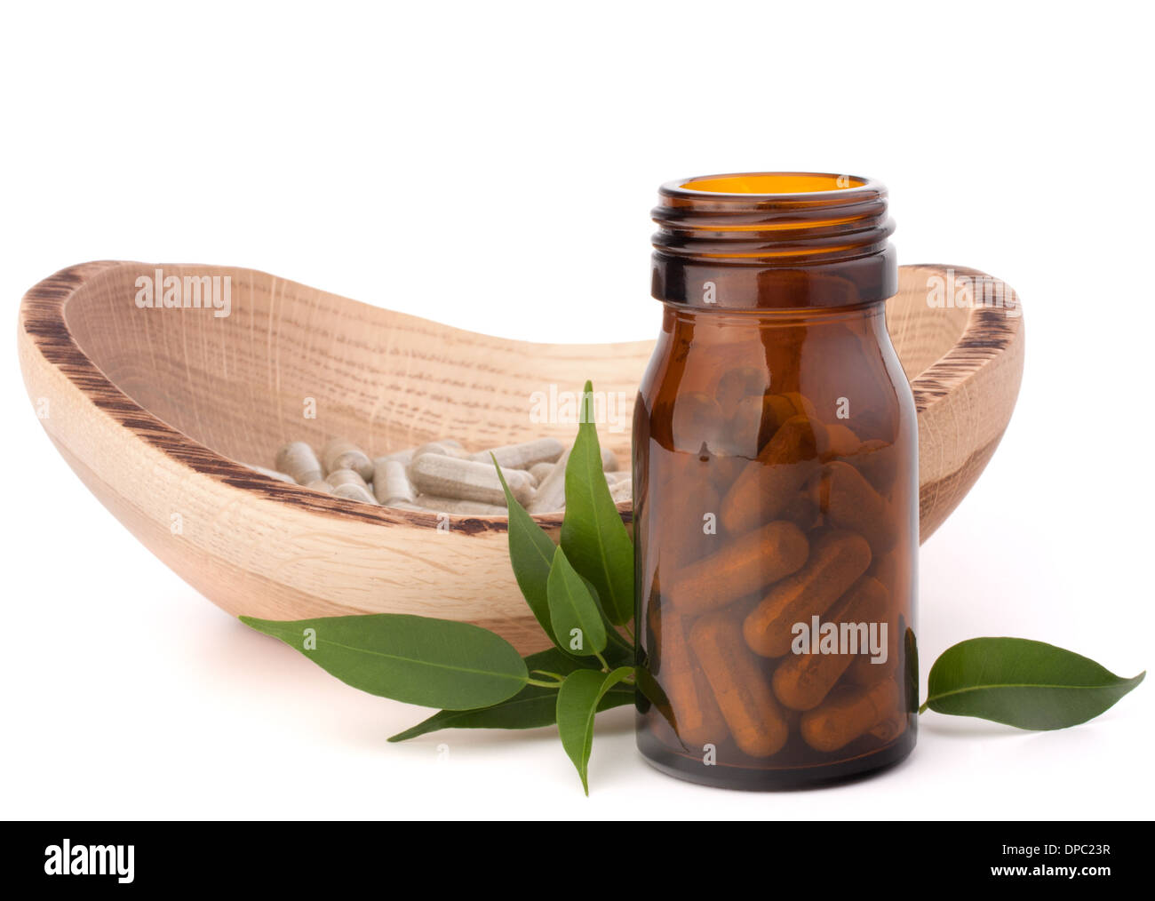 Herbal drug capsules in brown glass bottle isolated on white background