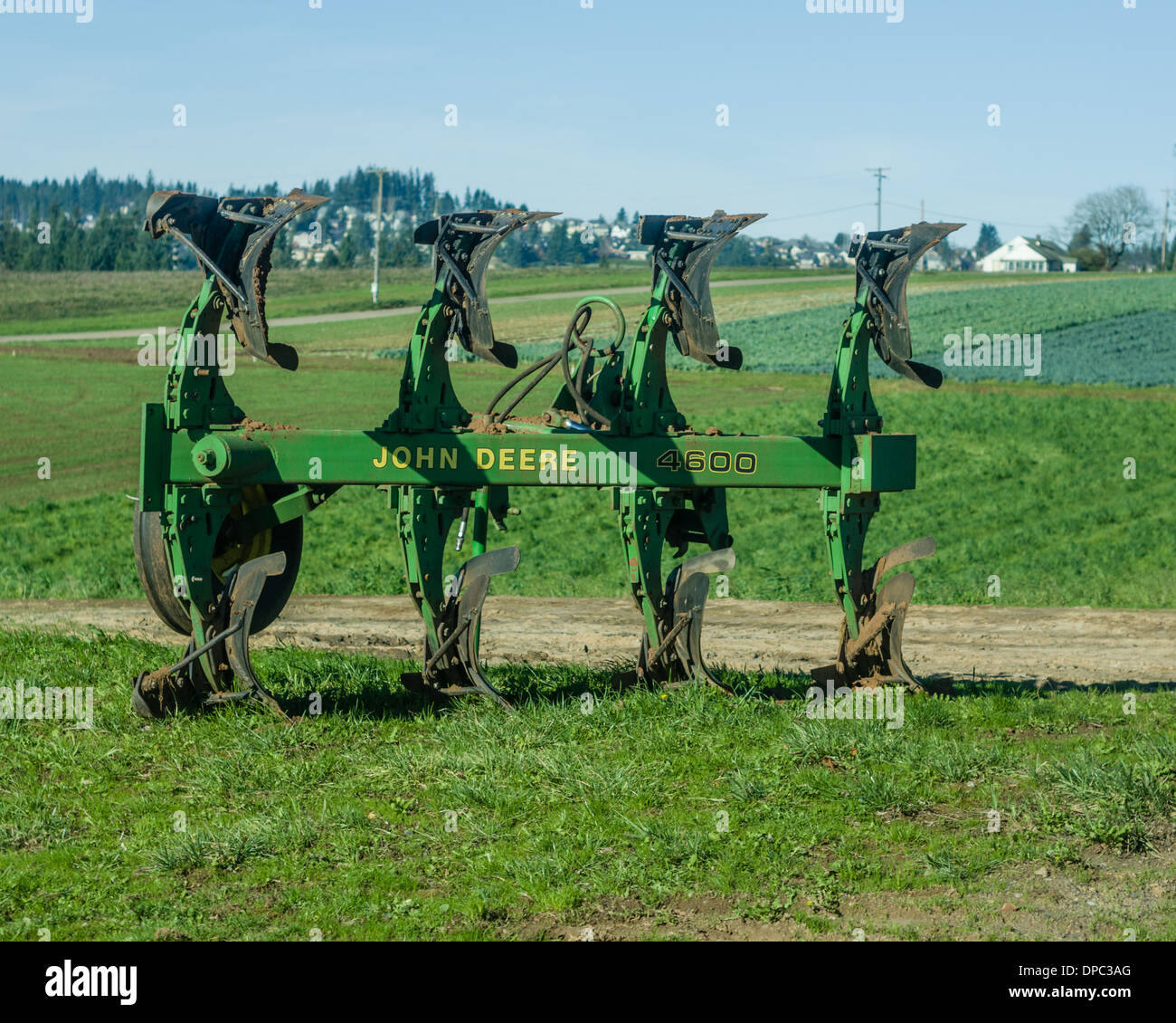 Four bottom roll over moldboard plow made by John Deere sitting in a