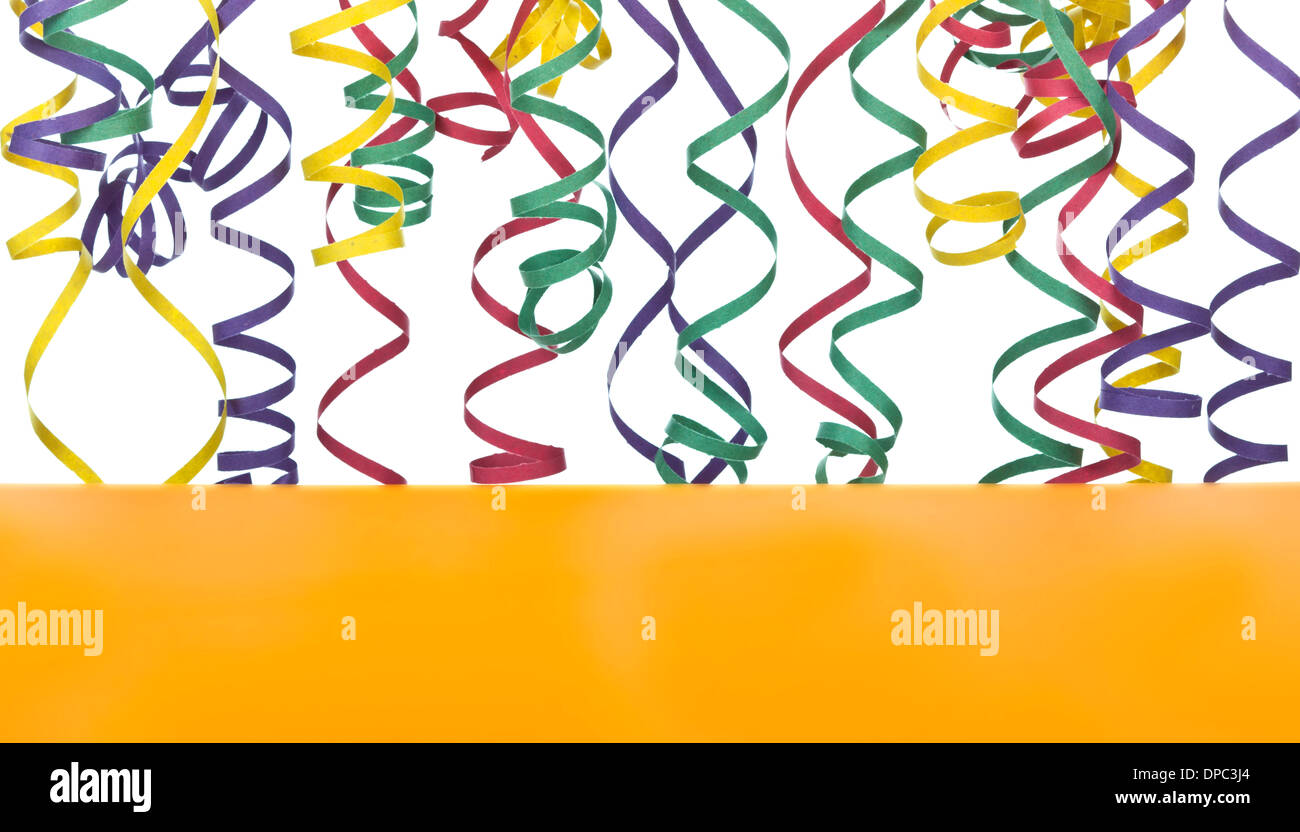 Colorful streamer on white background and orange table Stock Photo Alamy