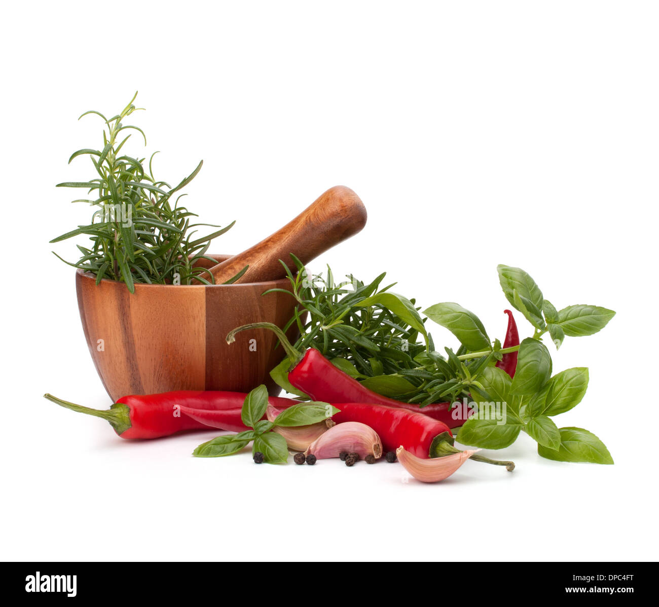 fresh flavoring herbs and spices in wooden mortar isolated on white background Stock Photo