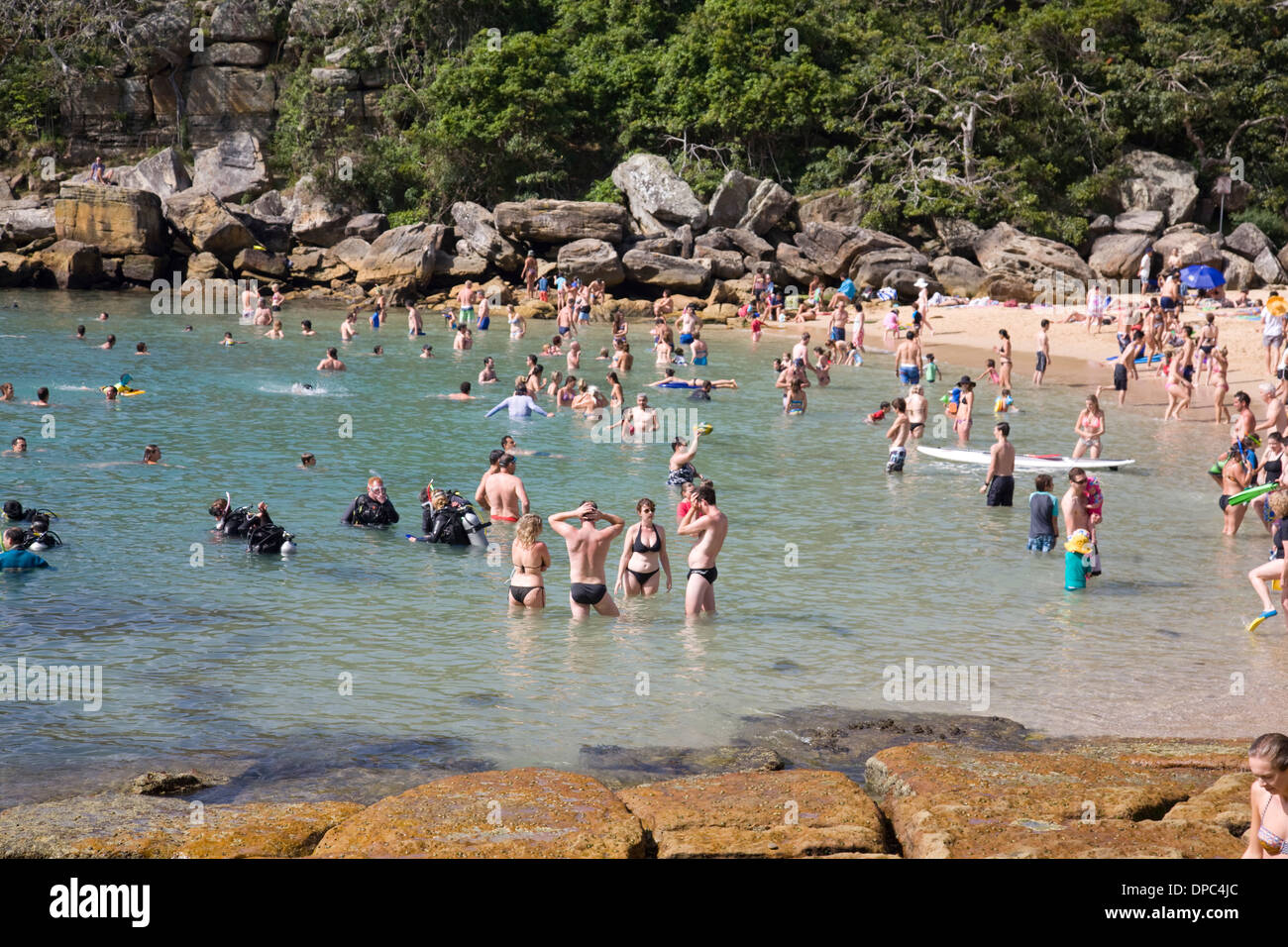 holiday makers stand in the ocean off shelly beach ,Manly,australia Stock Photo