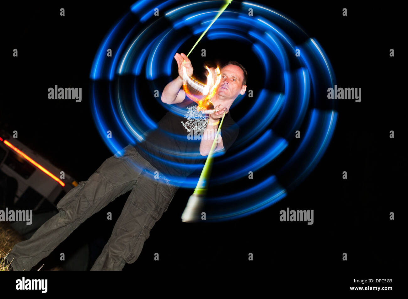 Man spinning poi Alchemy Festival UK 2011 Stock Photo
