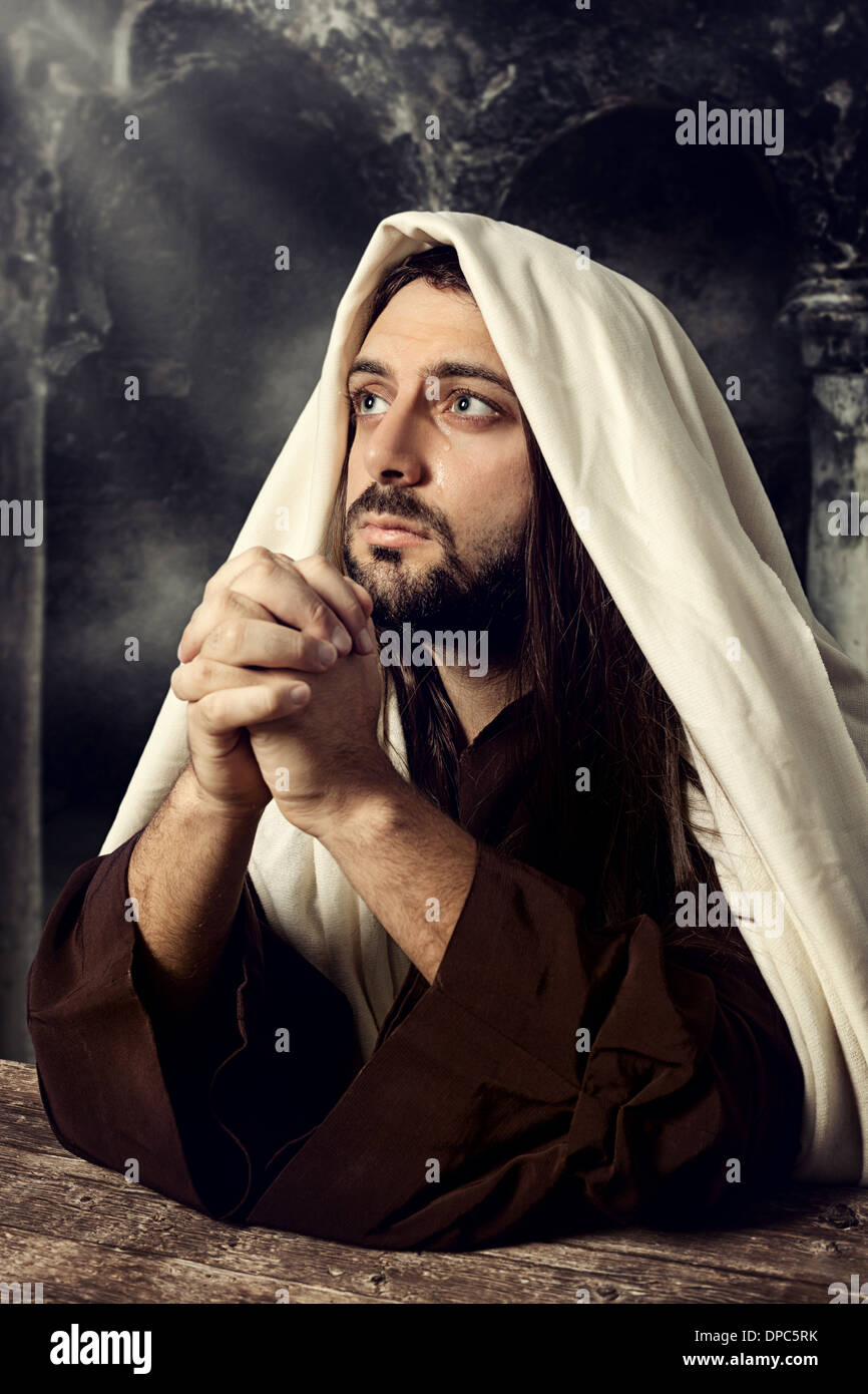 Jesus praying and looking up to heaven while he cries. Stock Photo