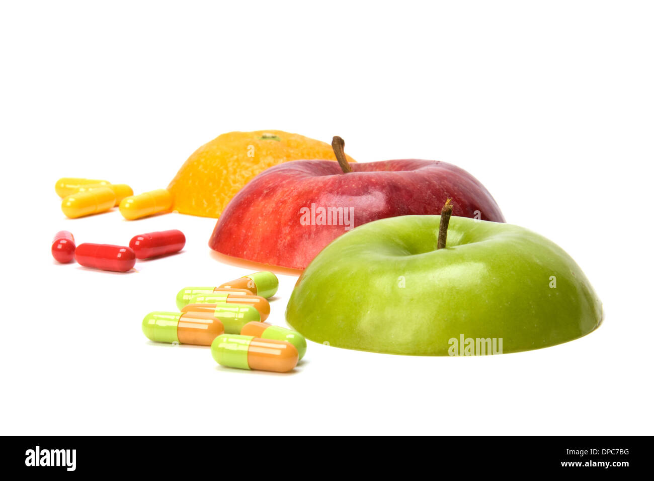 sliced fruits and pills isolated on white background Stock Photo