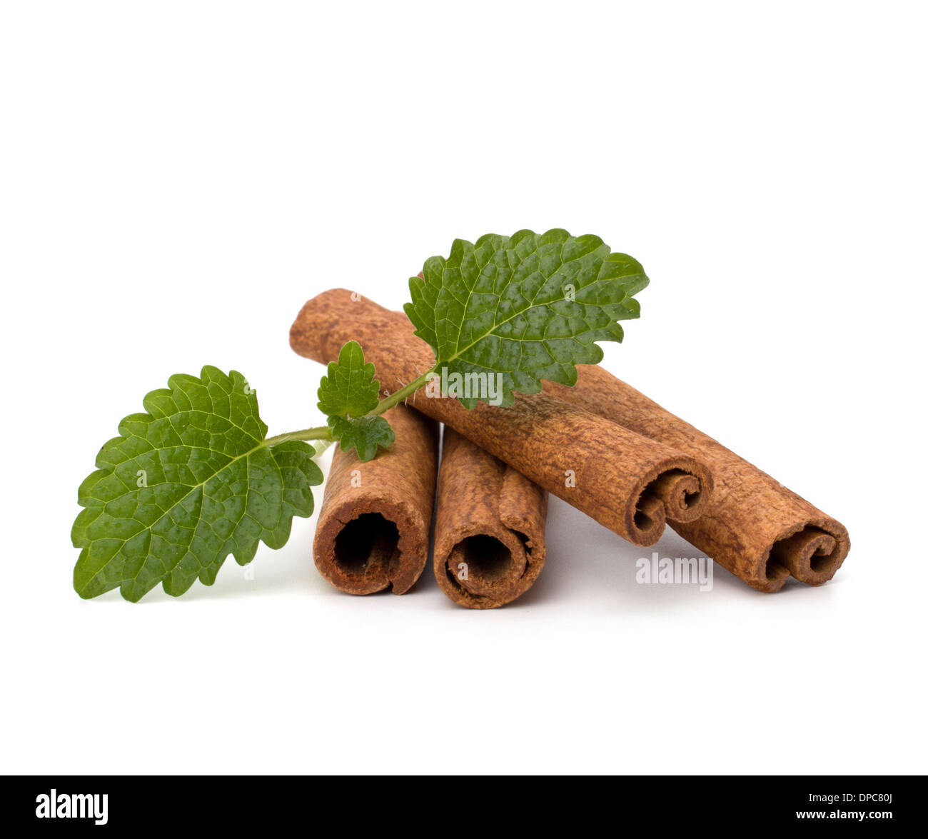 Cinnamon sticks and fresh bergamot mint leaf isolated on white background Stock Photo