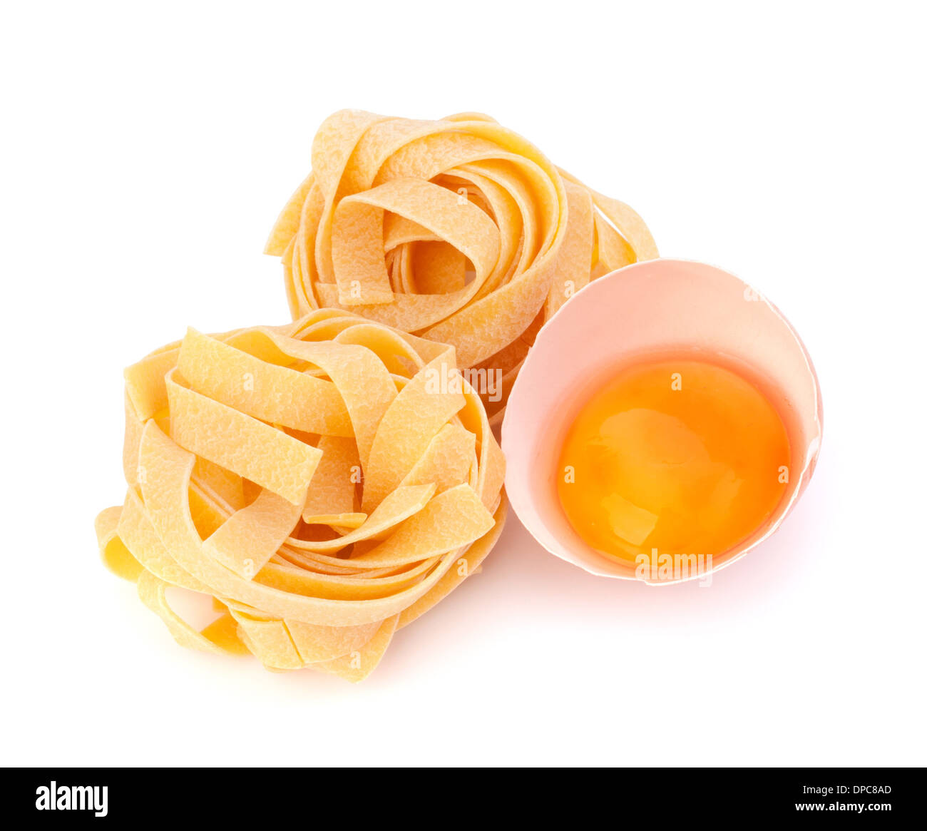 Italian egg pasta fettuccine nest isolated on white background Stock