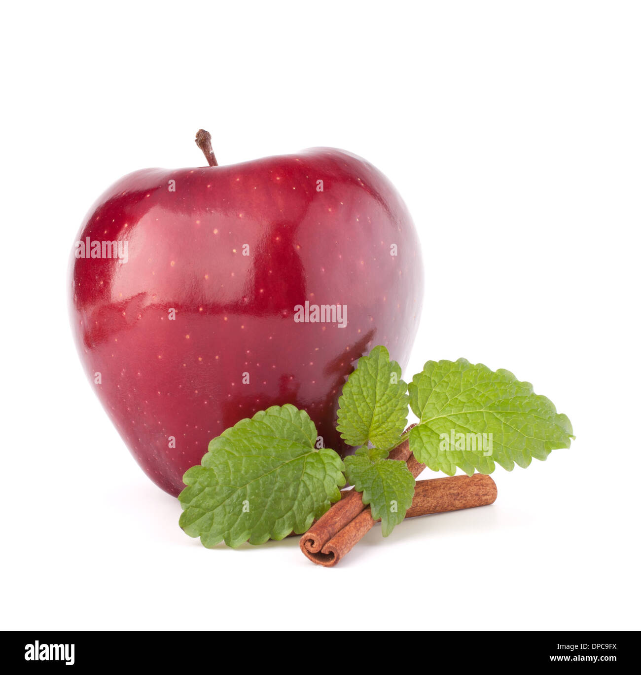 Red apple, cinnamon sticks and mint leaves still life isolated on white cutout. Stock Photo