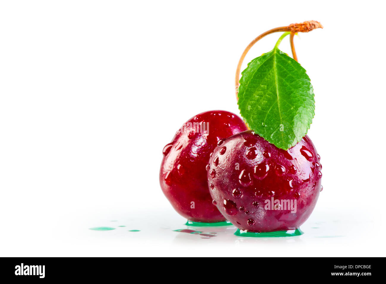 water drops on ripe cherries and leaf Stock Photo