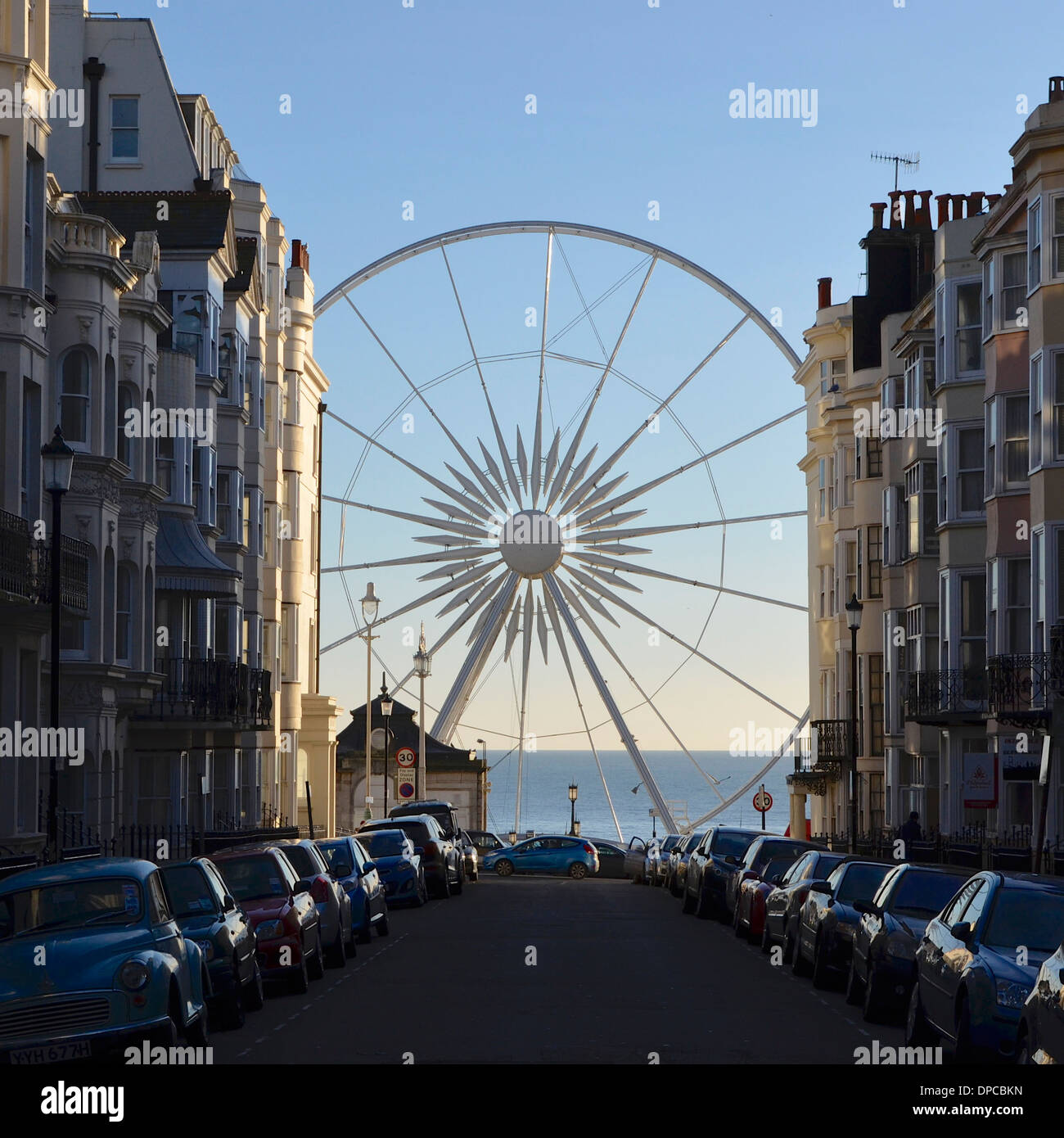 Brighton Wheel - Ferris Wheel viewed from Kemp Town with the sea in the background, framed by Victorian terraced town houses Stock Photo