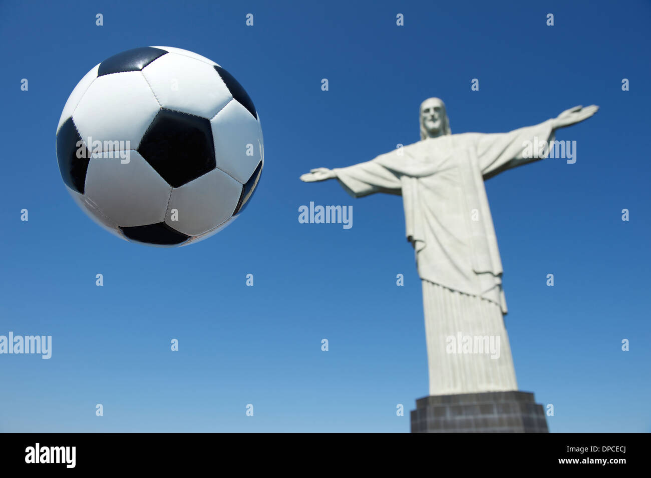 Brazil football soccer ball in the air bright blue sky Corcovado Cristo Redentor Rio de Janeiro Stock Photo