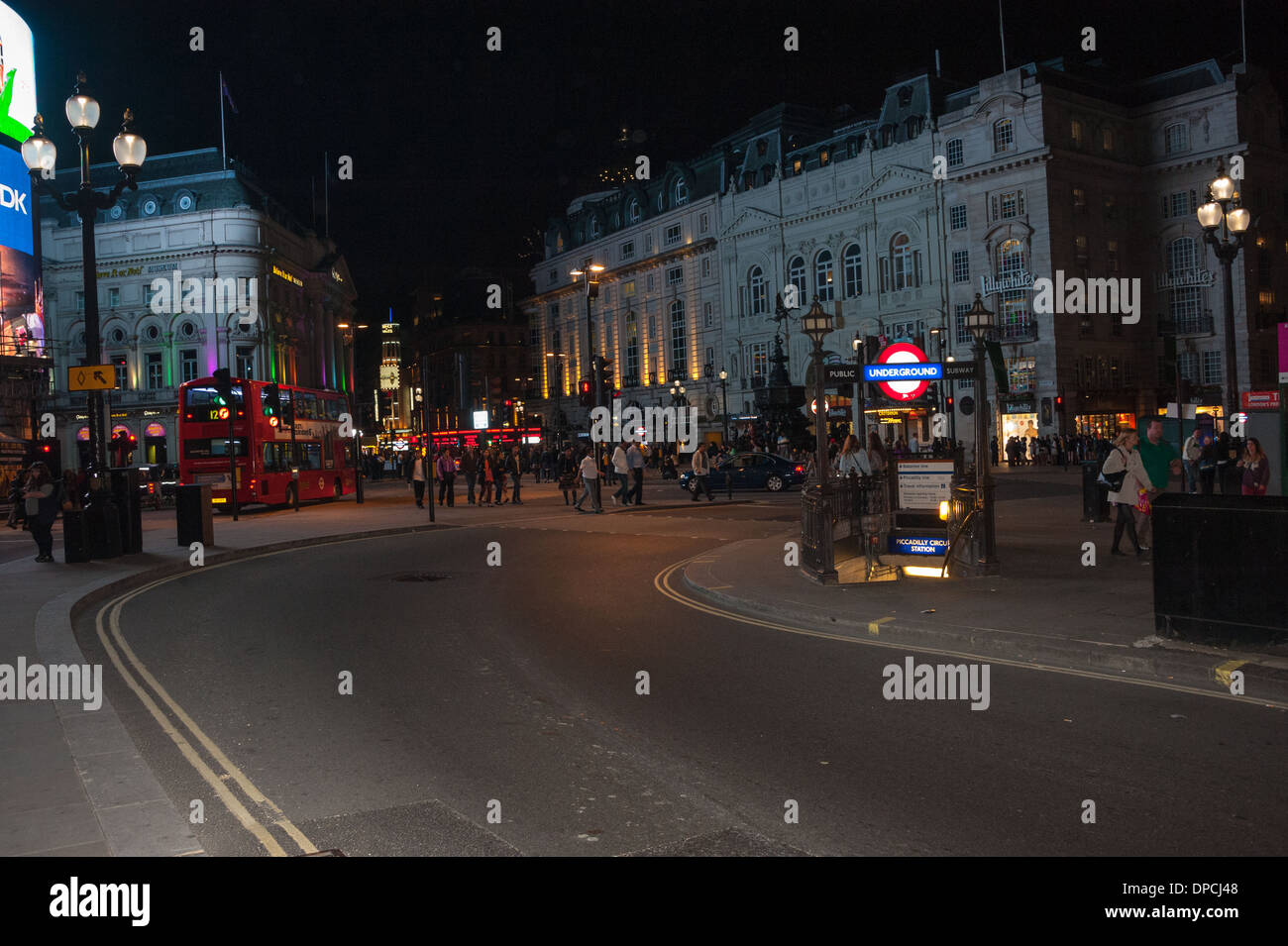 oxford street London looking down to  Piccadilly circus at night with red bus and london black cab tube station steps tourist Stock Photo