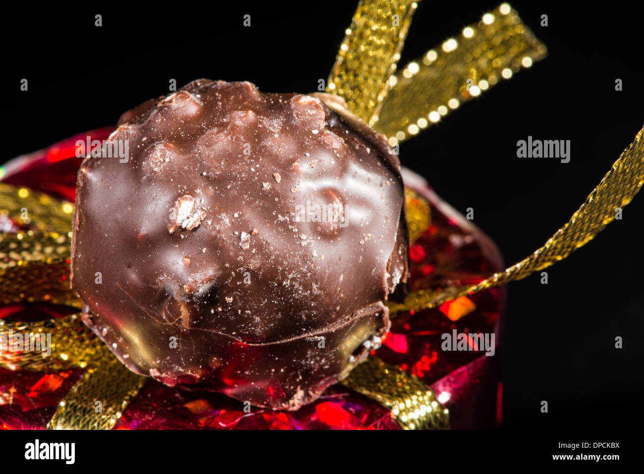 Chocolate bonbon and gold color shiny package Stock Photo