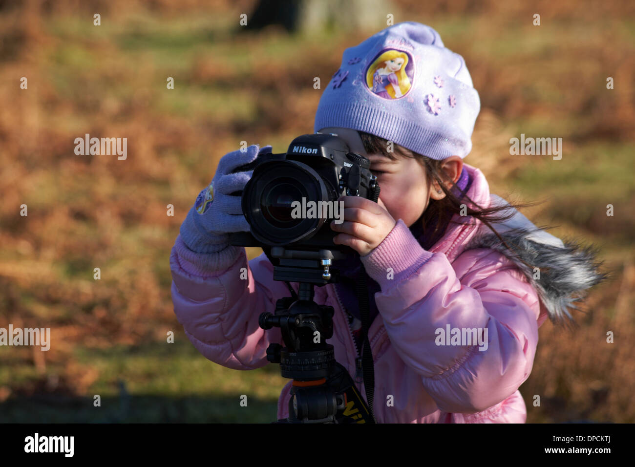 young photographer - young girl taking a photo with Nikon D800 camera on Acratech tripod Stock Photo