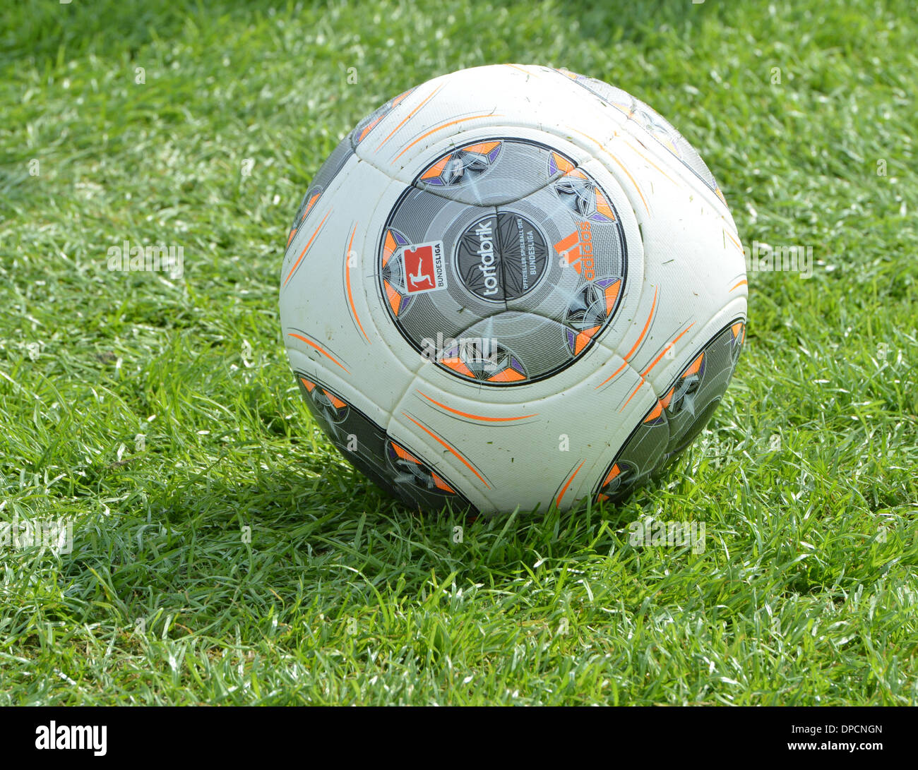 Doha, Qatar. 12th Jan, 2014. The Adidas soccer ball 'torfrabrik' lies on  the pitch during a training session of FC Bayern Munich in Doha, Qatar, 12  January 2014. Photo: PETER KNEFFEL/dpa/Alamy Live