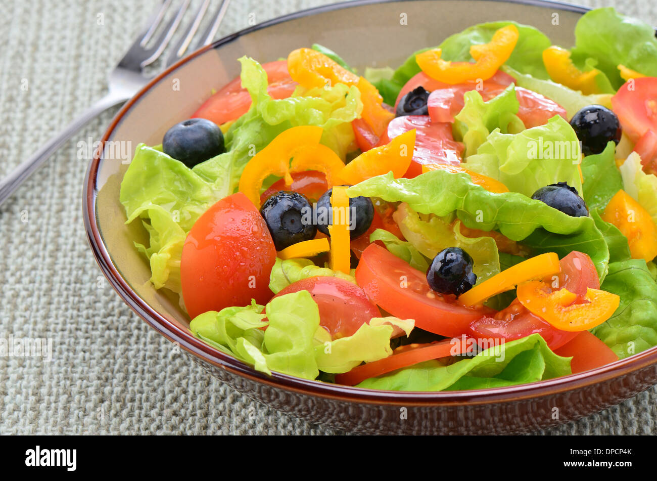 Fresh garden salad with butter lettuce, tomatoes, yellow pepper and