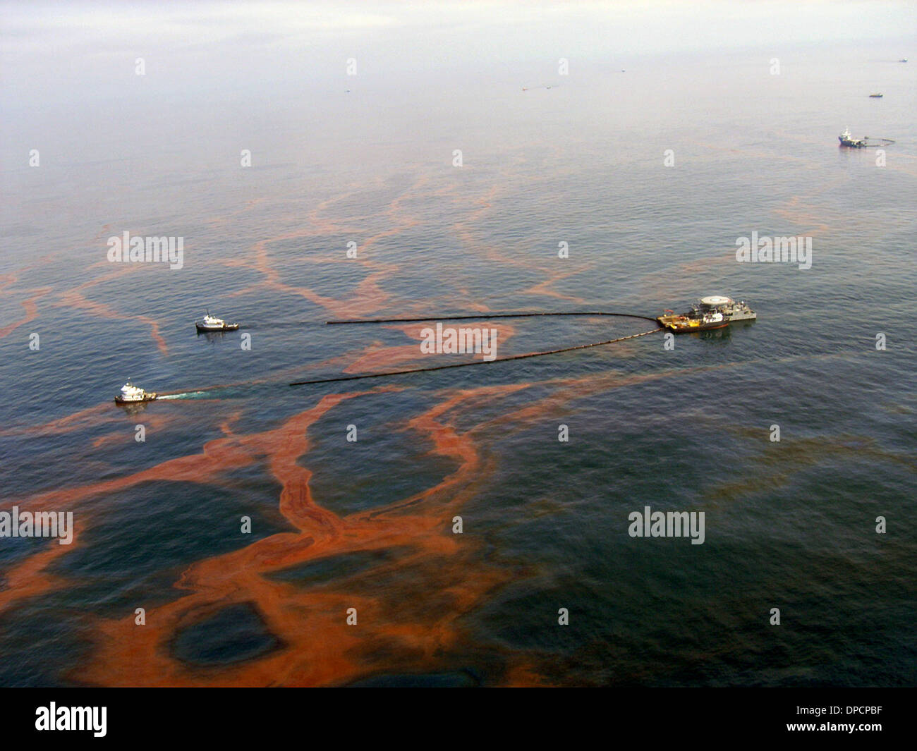 Aerial view clean up crews dragging containment booms to remove crude oil leaking from the blowout of the BP Oil Deepwater Horizon in the Gulf of Mexico July 30, 2010 near Grand Isle, Louisiana. Stock Photo