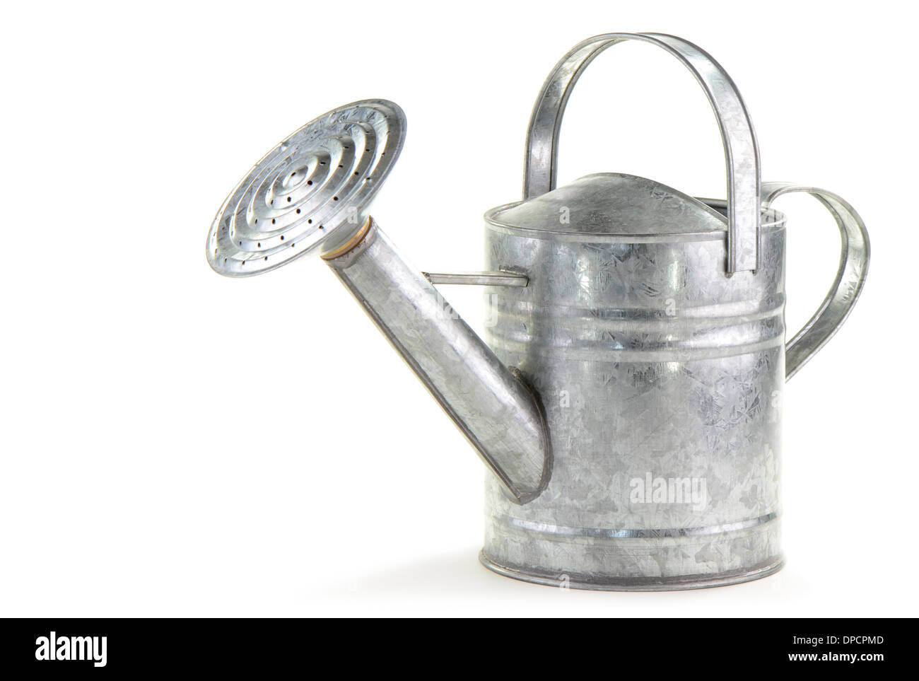 Tin watering can on white background with room for text Stock Photo